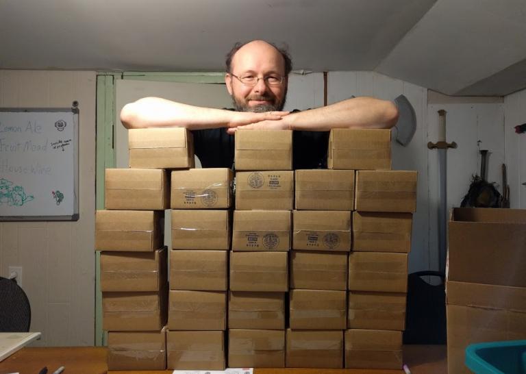 Tom with many boxes to send off to Kickstarter backers